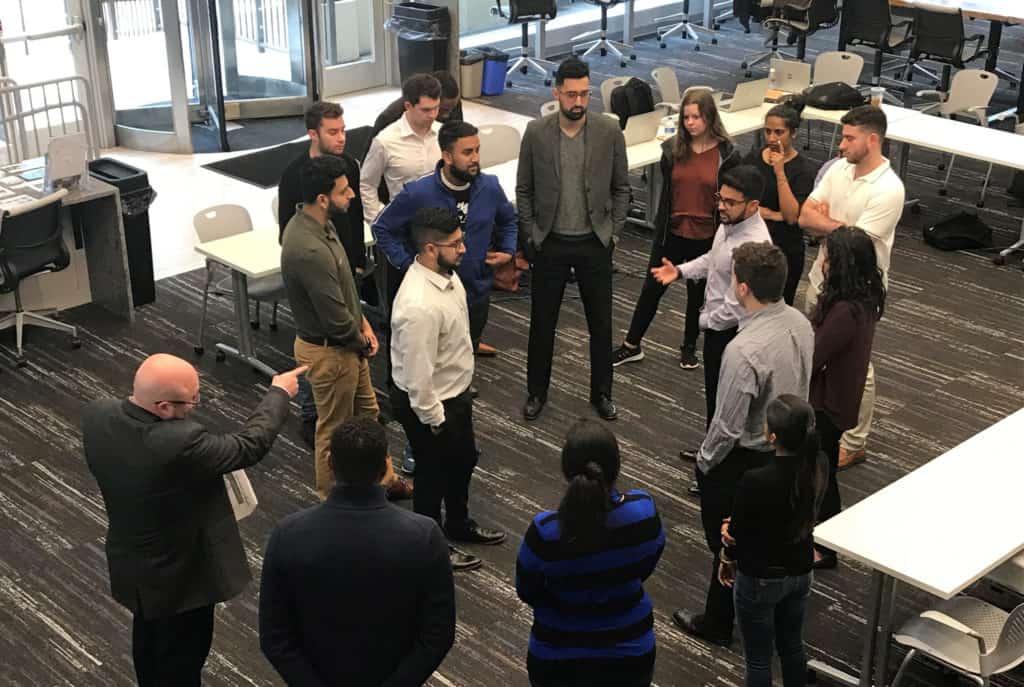 Joe Catrino (bottom right), Trinity’s director of career development and special assistant to the vice president for innovation, leads an Infosys training session at Trinity’s Liberal Arts Action Lab on Constitution Plaza.